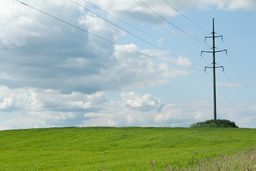 Image showing High-tension poles on background clouds