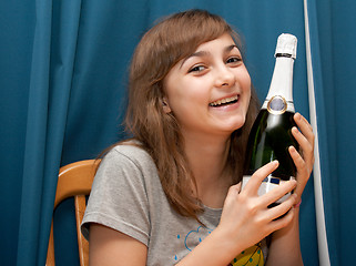 Image showing Girl with bottle champaign smiles