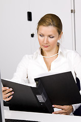 Image showing beautiful young woman working with documents