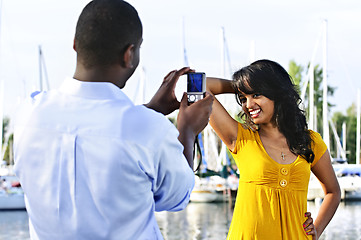 Image showing Woman posing for picture near boats