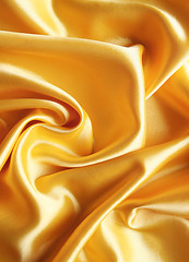 Image showing Smooth elegant golden satin as background 