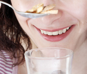 Image showing Young people eating milk with cereals