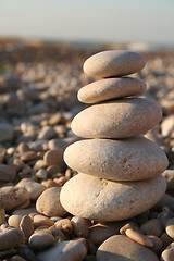 Image showing Pyramid of water rounded stones on the sea beach 