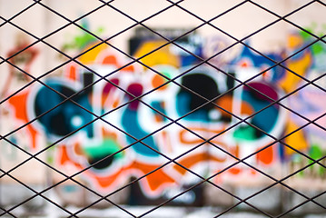 Image showing abstract graffiti through metal bars fence