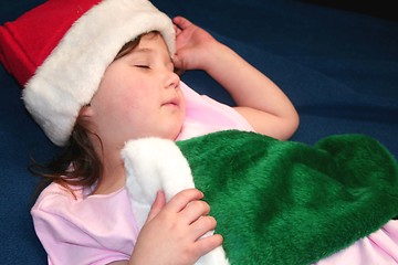 Image showing Cute little girl holding Christmas stocking