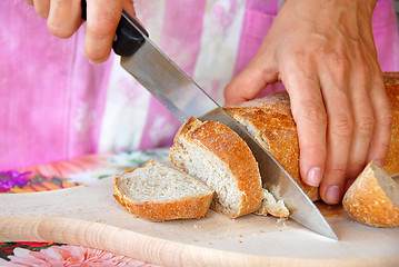 Image showing Cutting bread