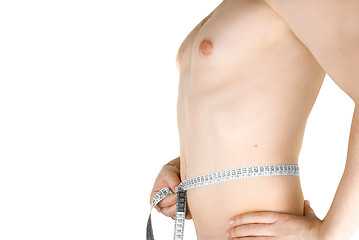 Image showing Young man measuring his body