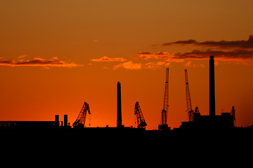 Image showing  Silhouette of sea port cranes in the evening  