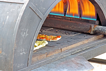 Image showing Preparing a tasty pizza in the oven