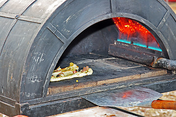 Image showing Preparing a tasty pizza in the oven