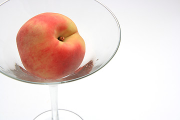 Image showing The fresh peach in the martini glass isolated on white backgroun
