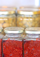 Image showing The jars with olives and paprika.