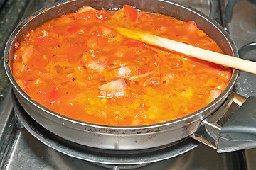 Image showing Healthy cooking. The pot with fresh vegetables in the tomato sau