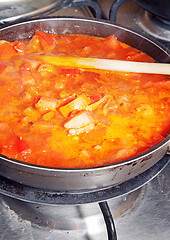Image showing Healthy cooking. The pot with fresh vegetables in the tomato sau