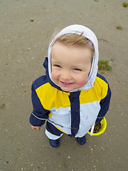 Image showing girl in the sand looking up