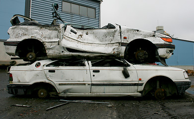 Image showing Two white cars on junk yard