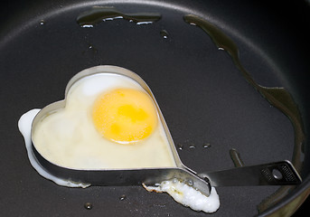 Image showing Fried egg in iron form heart crop