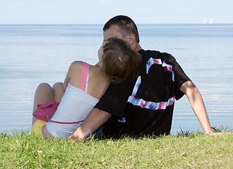 Image showing Lad and girl sit on herb