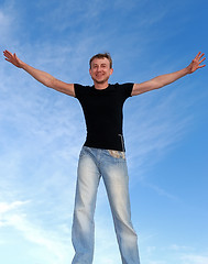 Image showing young happy man with open arms outdoors