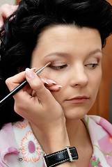 Image showing Making-up with eye shadow