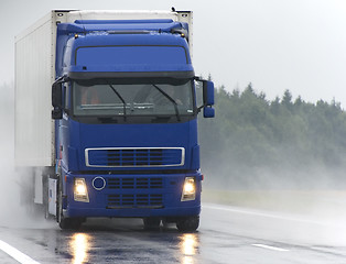 Image showing Blue Lorry on wet road