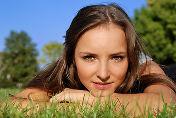 Image showing girl outdoors lying on the grass