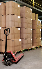 Image showing catron boxes and pallet truck in warehouse