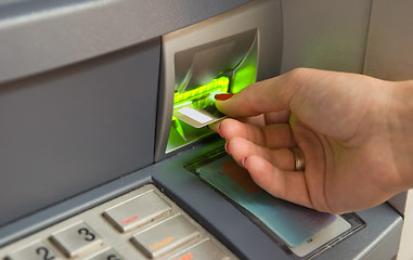 Image showing Inserting plastic card visa into ATM