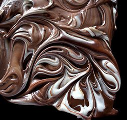 Image showing swirling milk chocolate with white chocolate