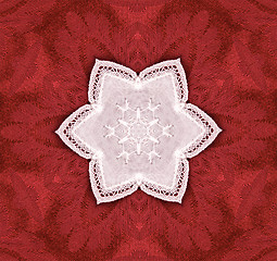 Image showing lace star on red tapestry