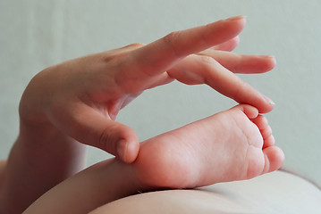 Image showing hand and child foot