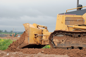 Image showing small bulldozer blade in action