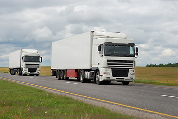 Image showing couple of white trucks on highway