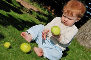 Image showing baby playing with apples