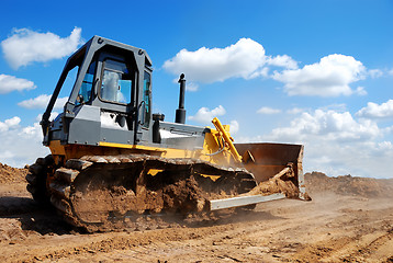 Image showing bulldozer with raised blade in action 