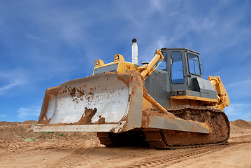 Image showing Heavy bulldozer with half raised blade in sandpit