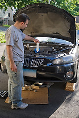 Image showing Man Changing the Oil