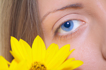 Image showing Female eye with a yellow flower