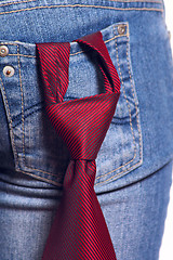 Image showing Red tie in a pocket female jeans