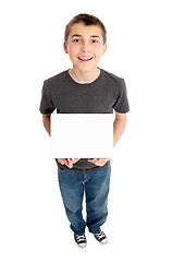 Image showing Boy holds a sign