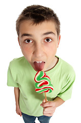 Image showing Boy licking lollipop