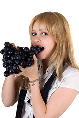 Image showing Portrait of the girl eating grapes. Isolated