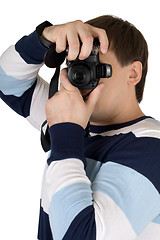 Image showing Young man with a digital camera. Isolated on white