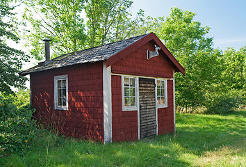 Image showing Brown wooden cabin in a forest