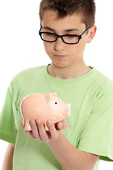 Image showing Boy holding a piggy bank money box