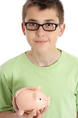 Image showing Smiling boy holds a money box