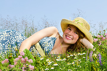 Image showing Young girl laying on meadow