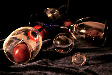 Image showing Glasses with plums both crystal and glass spheres 