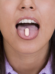 Image showing Pill on the tongue