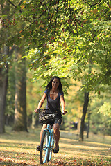 Image showing Woman riding a bicycle